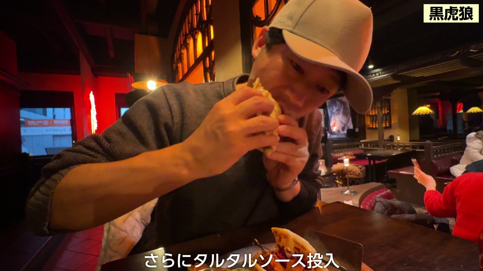 黒虎狼で、チキンと白身魚のタコスにかぶりつく
